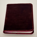 Black / dark red thread, red edges
